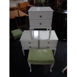 Three white two drawer bedside stands on raised legs together with a green dralon upholstered