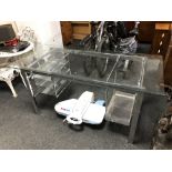 A contemporary glass topped twin pedestal desk on metal base