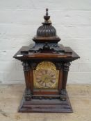 An Edwardian stained pine bracket clock with brass and silvered dial