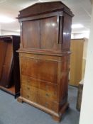 A 19th century mahogany secretaire chest fitted four drawers and double door cupboards above
