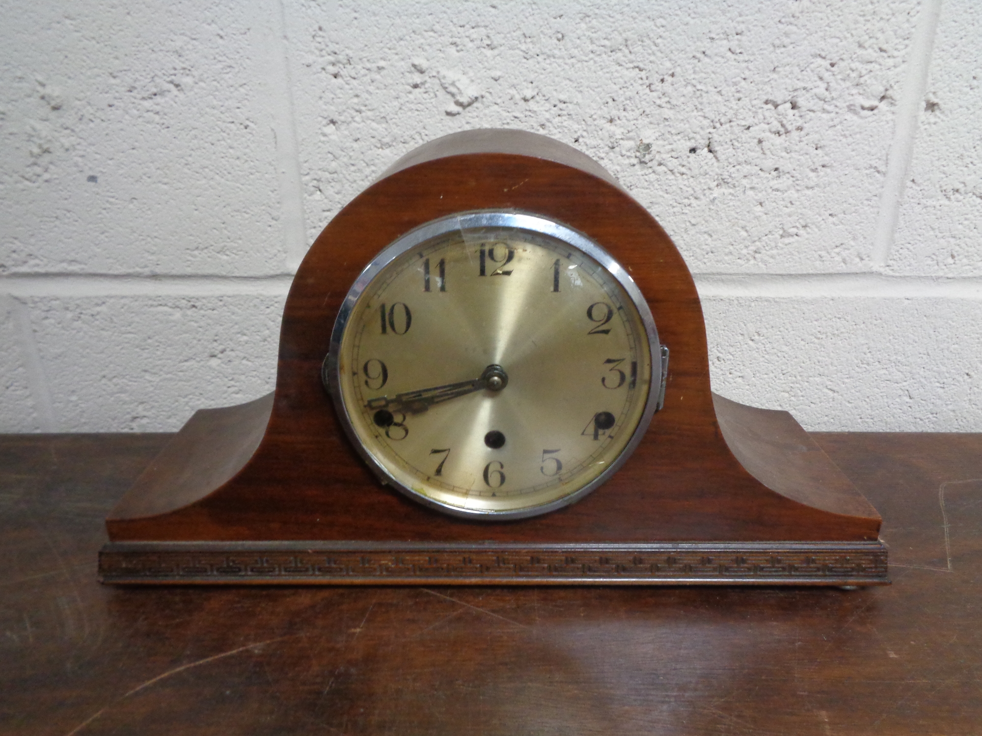 A 1930's walnut mantel clock with silvered dial