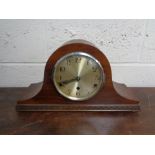 A 1930's walnut mantel clock with silvered dial