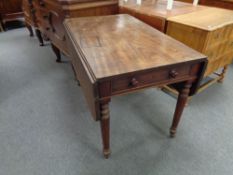 A Victorian mahogany drop leaf table fitted a drawer