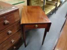 An antique mahogany Pembroke table fitted a drawer