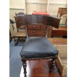 An antique oak elbow chair