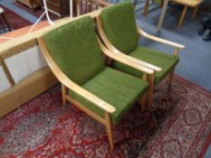 A pair of mid 20th century teak framed armchairs (green)