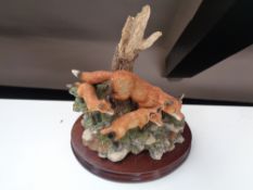 A Border Fine Arts figure of a fox family on wooden stand