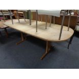 A late 20th century oval pine extending refectory dining table with leaf