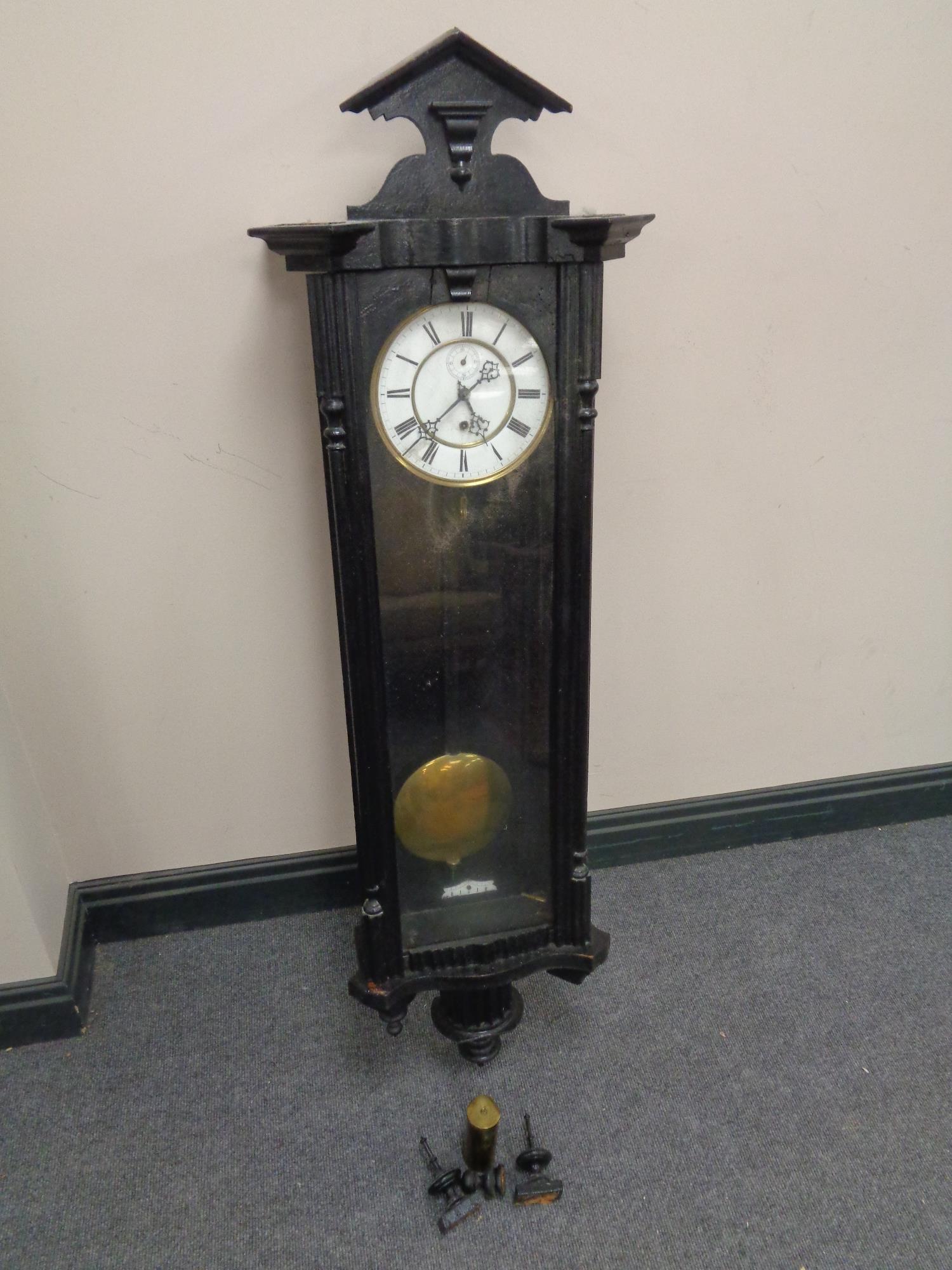 An early 20th century painted cased Vienna style wall clock