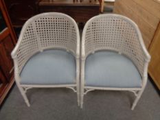 A pair of painted faux bamboo and bergere tub chairs, height 84 cm, width 59 cm, depth 54 cm.