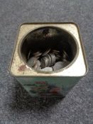 A vintage tin of one shilling and two shilling pieces