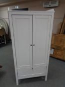An Ikea pine double door child's wardrobe fitted a drawer