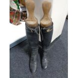 A pair of vintage leather riding boots with Peel & Co wooden boot stretchers