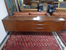 A mid 20th century teak low sideboard fitted with cupboards and drawers, height 75 cm, width 221 cm,