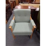 A 20th century oak framed armchair upholstered in a green fabric