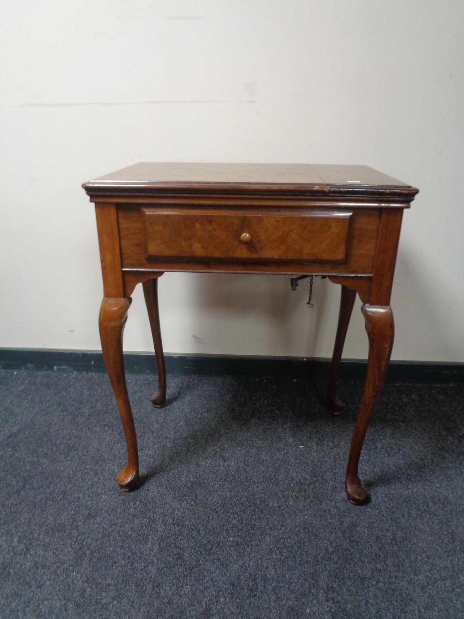 A walnut sewing machine table