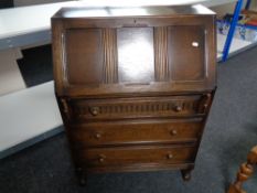 A 20th century oak bureau, height 107 cm, width 76 cm, depth 41 cm.