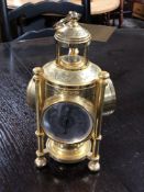 A decorative brass triple aspect lantern clock/barometer/biometric pressure monitor also fitted