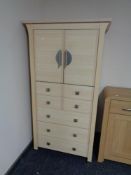 A contemporary pine effect cabinet fitted five drawers