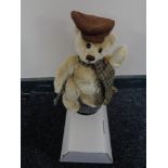 A Franklin Mint Heirloom bear on stand.