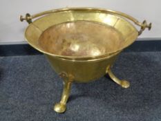 An antique brass Art Nouveau coal bucket on raised legs