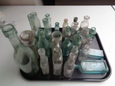 A tray of assorted antique glass bottles