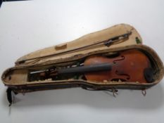 An early 20th century violin and bow in coffin case, needing attention, back length 33 cm.