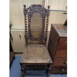 An antique carved oak and bergere hall chair