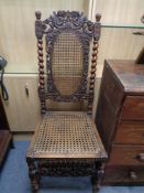 An antique carved oak and bergere hall chair