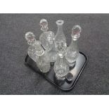 A tray of seven assorted cut glass and lead crystal decanters with stoppers