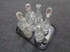 A tray of seven assorted cut glass and lead crystal decanters with stoppers