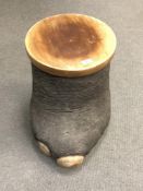 An early twentieth century elephants foot storage pot with wooden lid and lining, height 44 cm.