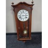 A 20th century eight day wall clock with pendulum and key