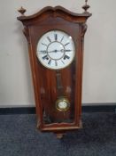 A 20th century eight day wall clock with pendulum and key