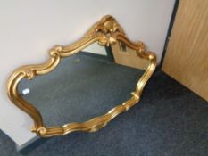 A shaped gilt framed overmantel mirror