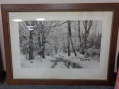 An early twentieth century monochrome print depicting a continental winter woodland