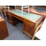 An antique pine twin pedestal writing desk fitted three drawers with leather inset panel