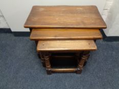 A nest of three oak tables