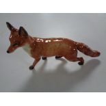 A large Beswick figure, fox walking.