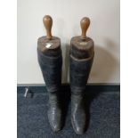 A pair of vintage leather riding boots with Faulkner's & Sons wooden boot stretchers