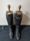 A pair of vintage leather riding boots with Faulkner's & Sons wooden boot stretchers