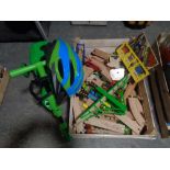 A crate containing scuttlebug with helmet, large quantity of wooden train track trains,