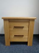 A contemporary oak bedside stand