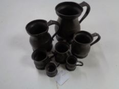 Seven antique pewter tankards/measures