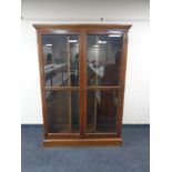 A late 19th century oak glazed door bookcase with adjustable shelves,