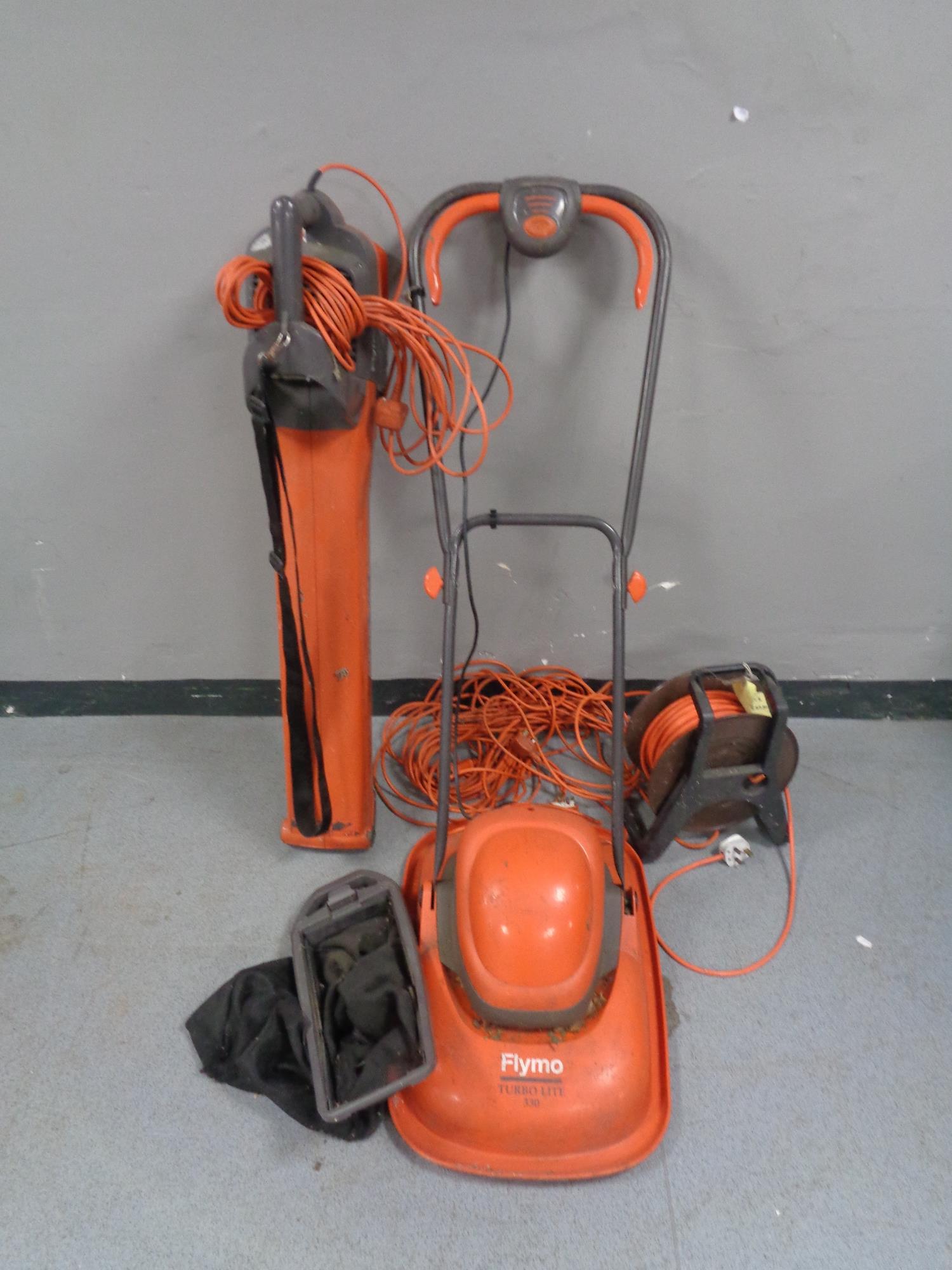 A Flymo garden vacuum together with a Flymo mower and extension lead