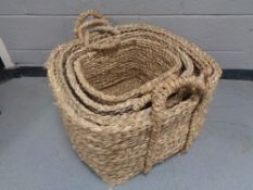 A set of four large graduated wicker baskets with handles