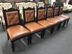 A set of six antique carved oak dining chairs in brown buttoned leather