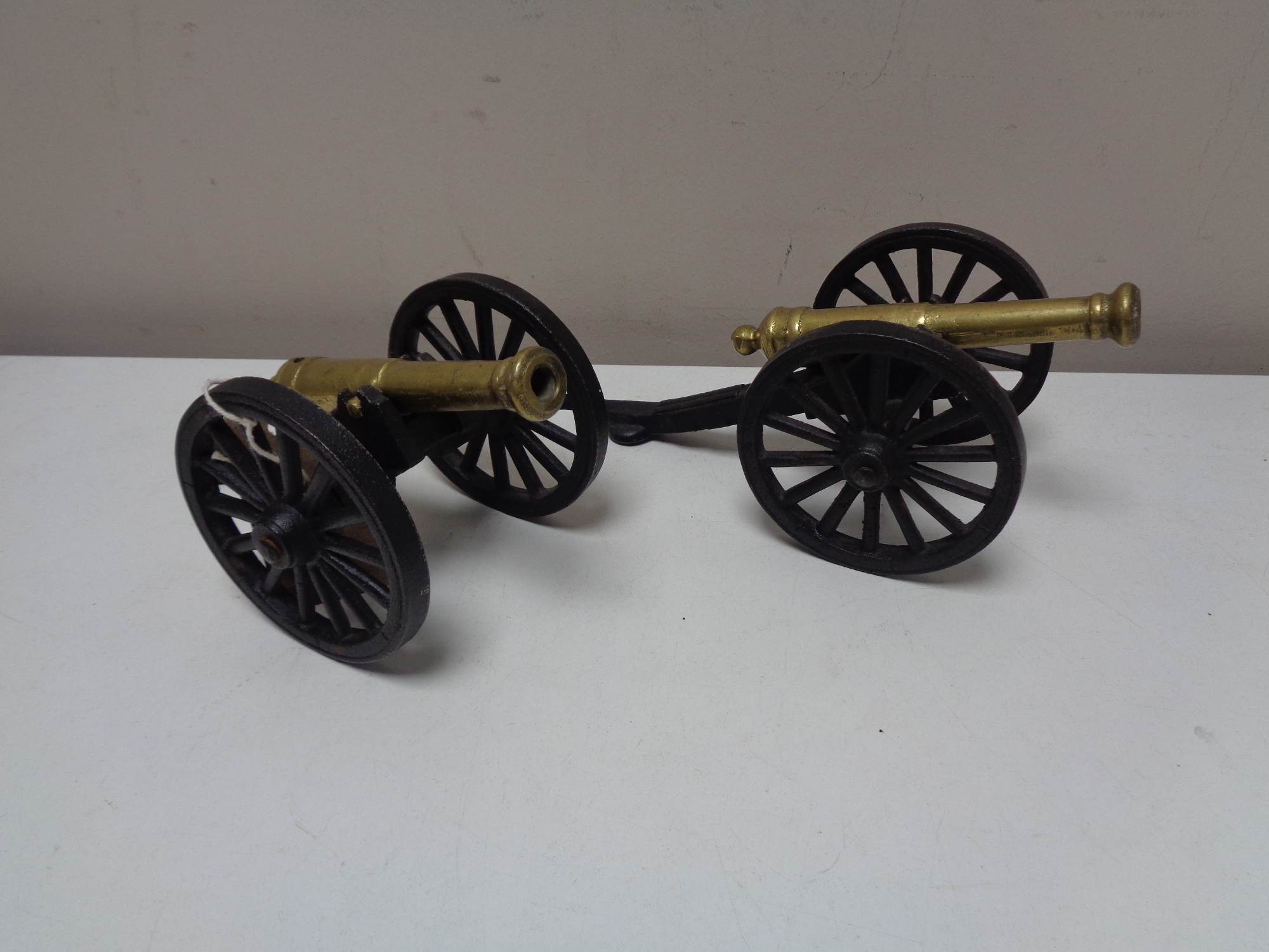 A pair of brass and metal cannons