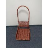 A wicker and metal log trolley